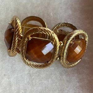 Gold and and light caramel colored bracelet.